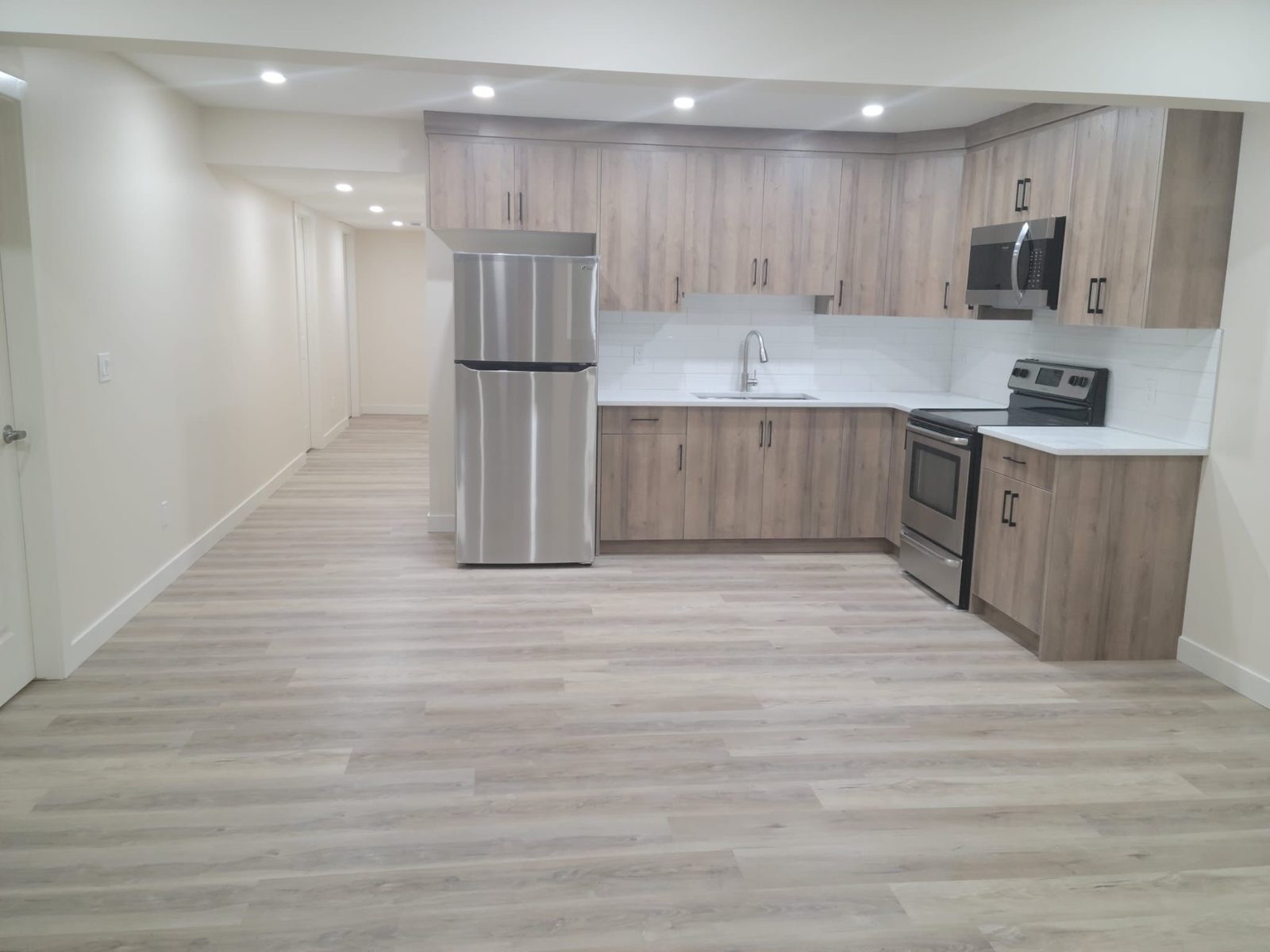 Finished basement secondary suite with open-plan kitchen and living area